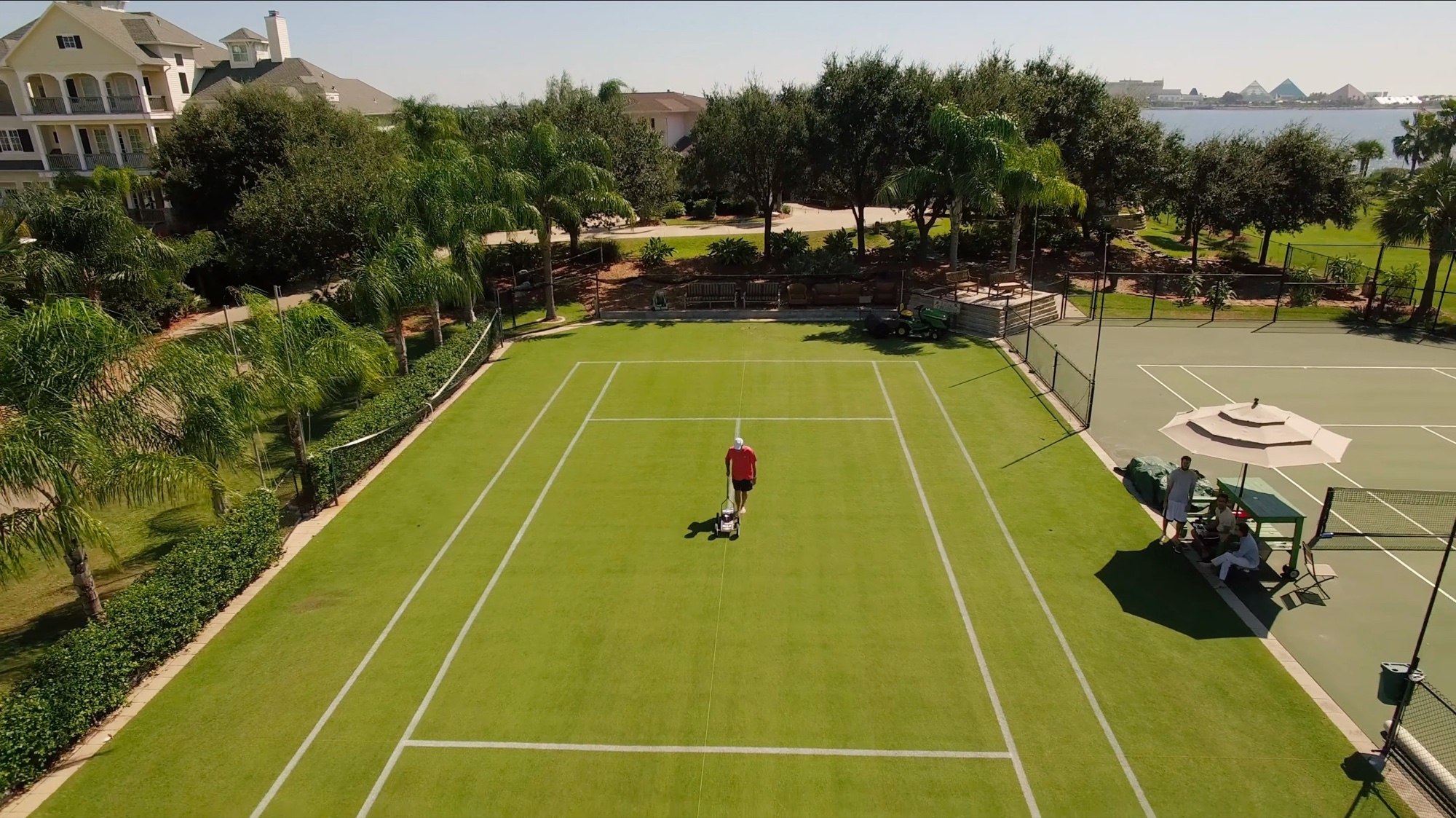 The grass court and hard court from the air, with Offatts Bayou beyond